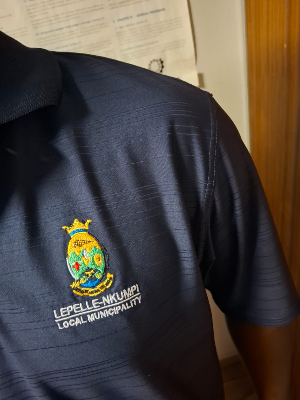 Navy golf shirt with embroidered Lepelle-Nkumpi Local Municipality badge